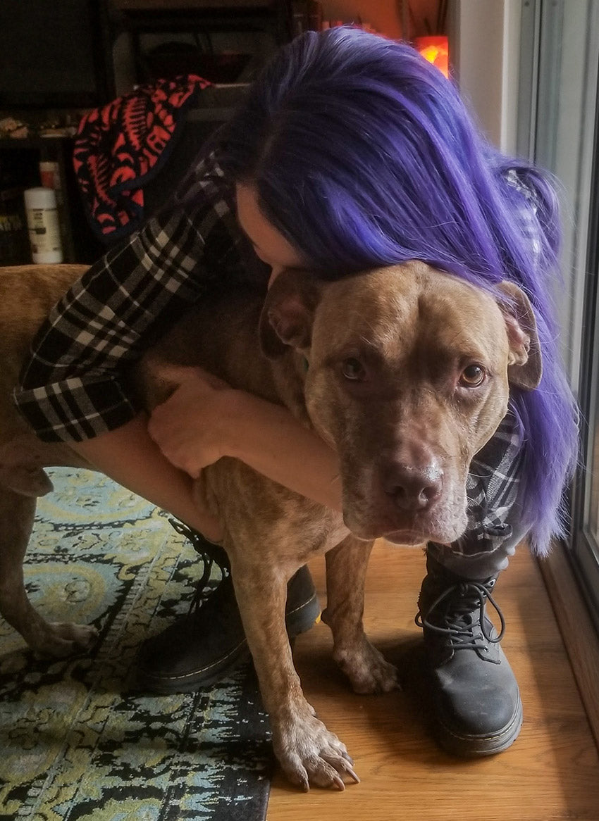 Girl hugging her senior dog